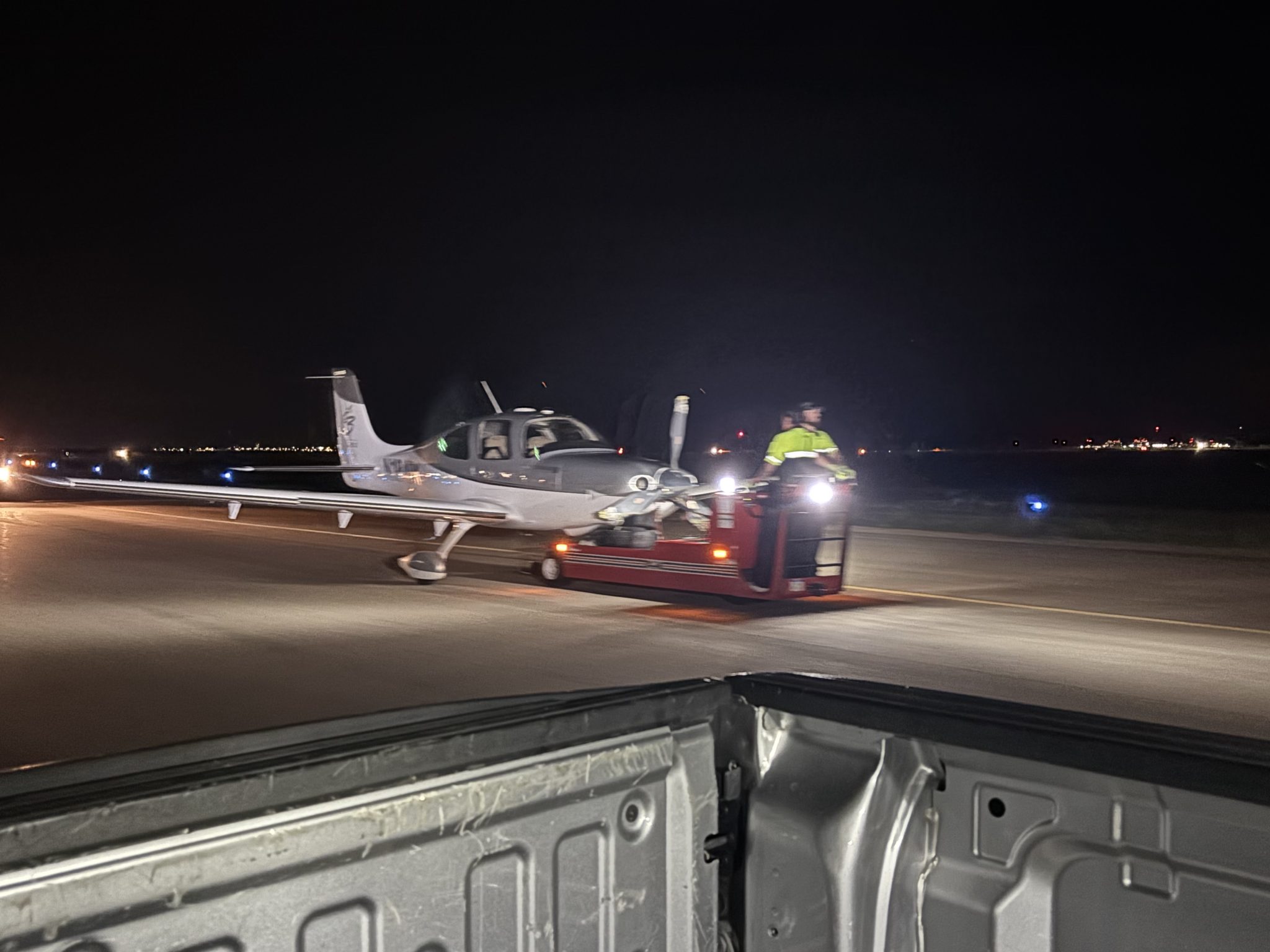 Saber technician moving an aircraft on the ramp at night